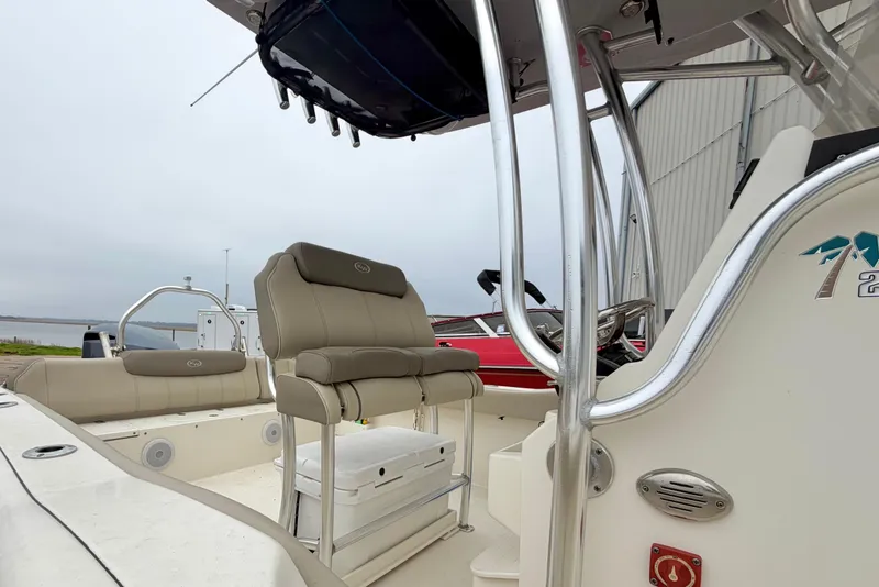 Slide: The Image of 2021 Key West 239 FS boat interior with seating and console, docked near water. - 15