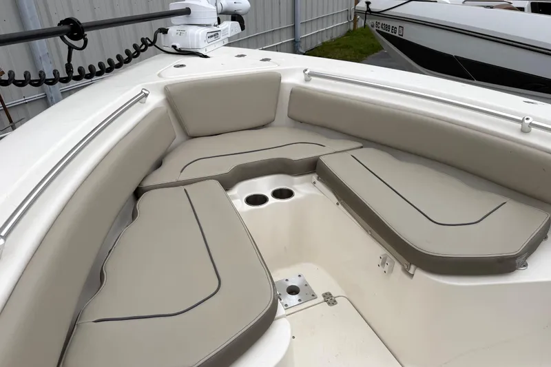 Slide: The Image of 2021 Key West 239 FS boat interior with cushioned seating and cup holders. - 17