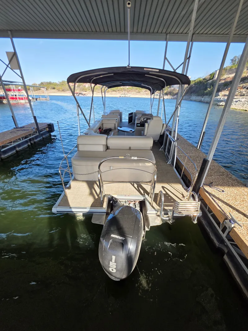 Slide: The Image of Harris FloteBote 250CR 2021 pontoon boat docked with outboard motor. - 12