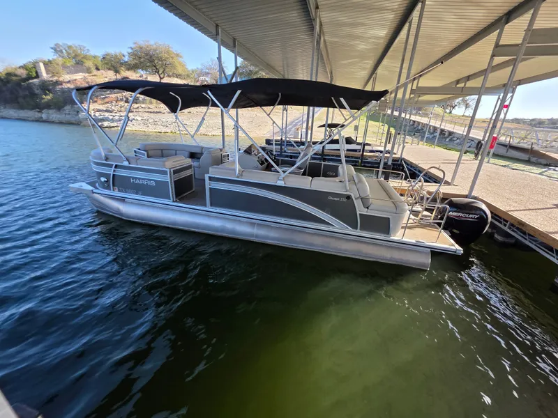 Slide: The Image of 2021 Harris FloteBote 250CR pontoon boat docked. - 13
