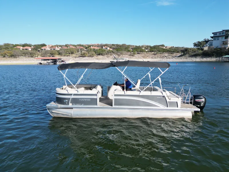 Slide: The Image of 2021 Harris FloteBote 250CR pontoon boat on a calm lake. - 20