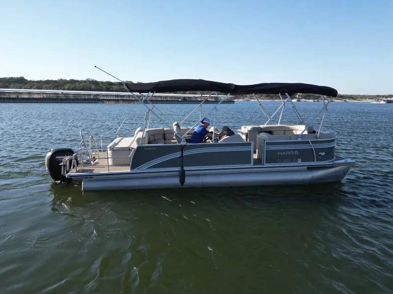 Slide: The Image of 2021 Harris FloteBote 250CR pontoon boat on the water. - 22