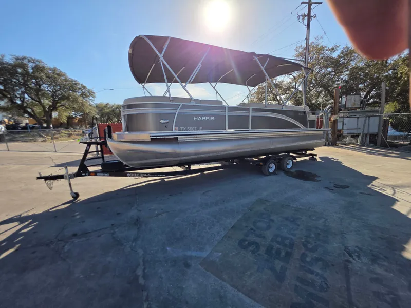 Slide: The Image of 2021 Harris FloteBote 250CR pontoon boat on trailer outdoors. - 5