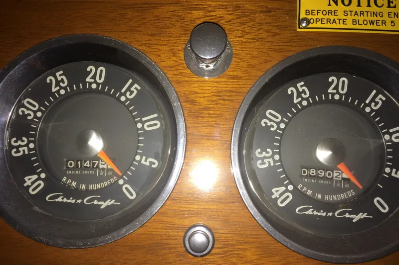 Slide: The Image of 1958 Chris-Craft 31 Sedan Cruiser dashboard with dual RPM gauges and engine hour meters. - 16