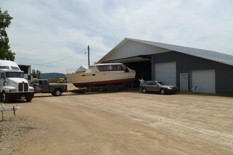 Slide: The Image of 1958 Chris-Craft 31 Sedan Cruiser being transported from a large garage. - 4