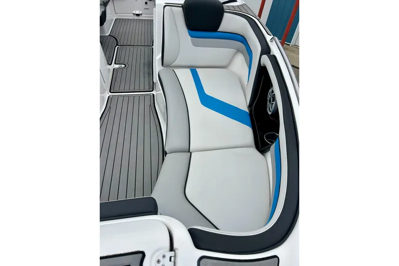 Slide: The Image of 2018 Yamaha Boats 242X interior with sleek white and blue seating design. - 12