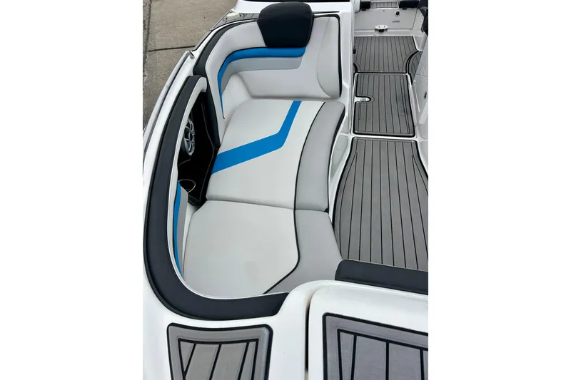 Slide: The Image of 2018 Yamaha Boats 242X interior with gray and blue seating, sleek design. - 13