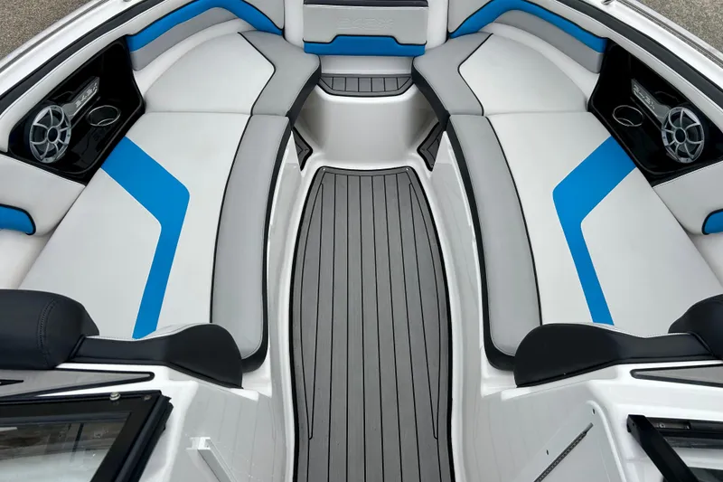 Slide: The Image of 2018 Yamaha Boats 242X interior with blue and gray seating, featuring sleek design and speakers. - 20