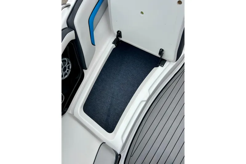 Slide: The Image of Open storage compartment on 2018 Yamaha Boats 242X, featuring sleek interior design. - 24