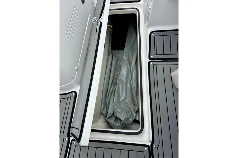 Slide: The Image of Open storage compartment on 2018 Yamaha Boats 242X, featuring sleek deck design. - 36