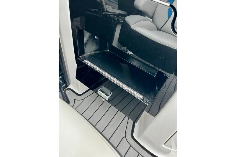 Slide: The Image of 2018 Yamaha Boats 242X interior storage compartment with sleek design and seating. - 48