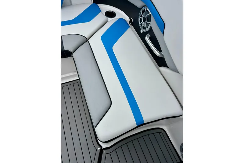 Slide: The Image of 2018 Yamaha Boats 242X interior seating with blue and white upholstery, featuring speaker and handle. - 49