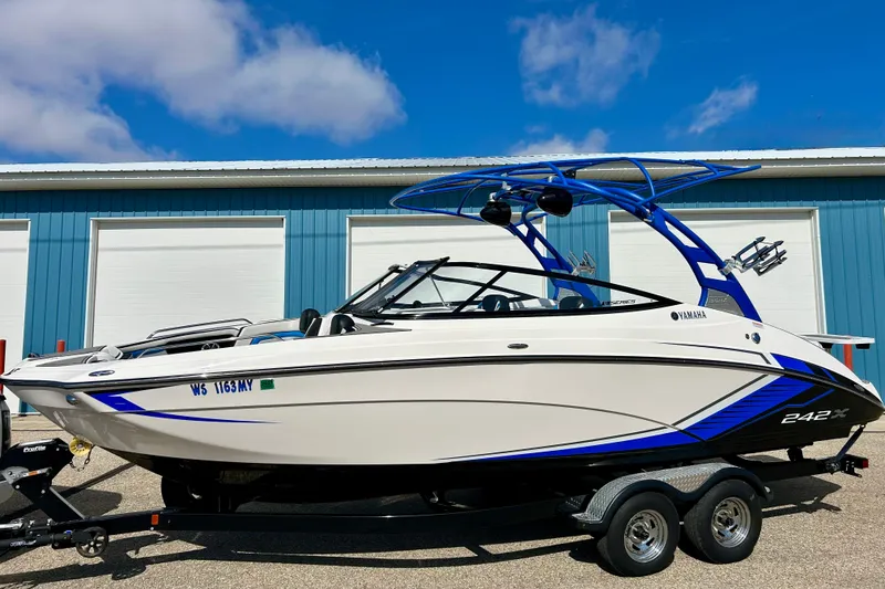 Slide: The Image of 2018 Yamaha Boats 242X on trailer, parked outdoors under blue sky. - 5