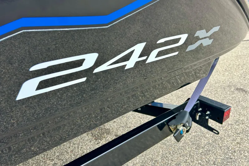 Slide: The Image of 2018 Yamaha Boats 242X model logo on a sleek black hull. - 6