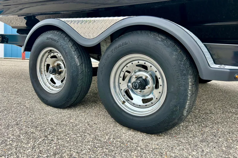 Slide: The Image of Trailer wheels of a 2018 Yamaha Boats 242X on asphalt surface. - 71
