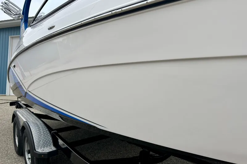 Slide: The Image of 2018 Yamaha Boats 242X on trailer, sleek white hull with blue accents. - 8