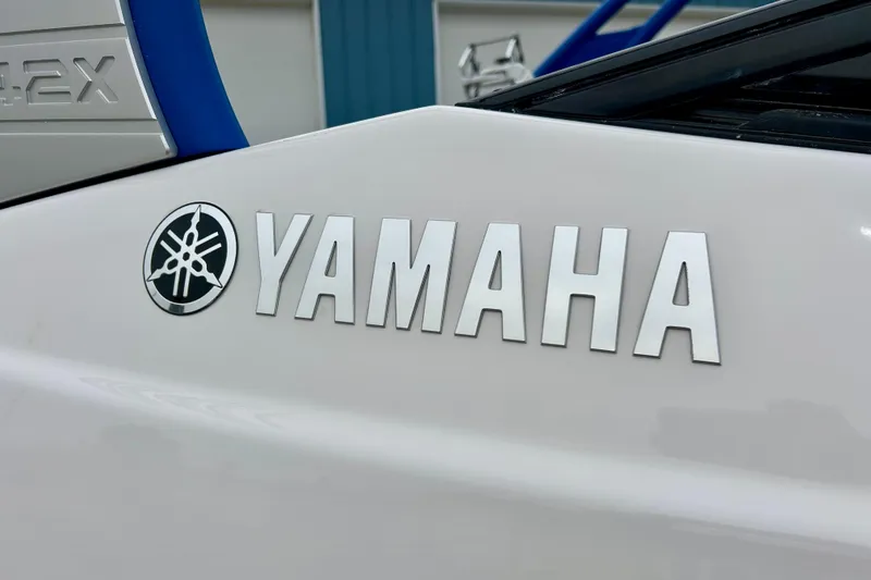 Slide: The Image of 2018 Yamaha Boats 242X logo on white surface, featuring bold lettering and emblem. - 9