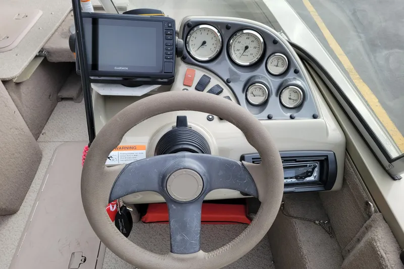Slide: The Image of 2005 Lowe Fish & Ski 165 dashboard with steering wheel and Garmin GPS. - 10