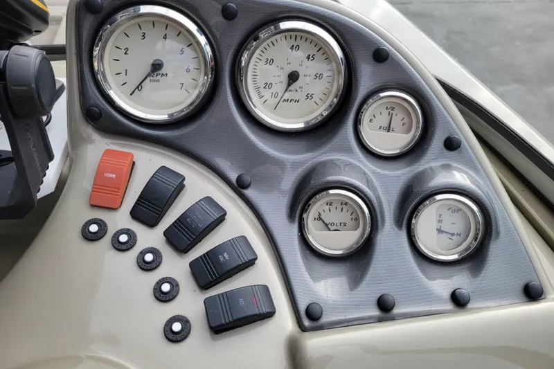 Slide: The Image of 2005 Lowe Fish & Ski 165 dashboard with gauges and switches. - 12