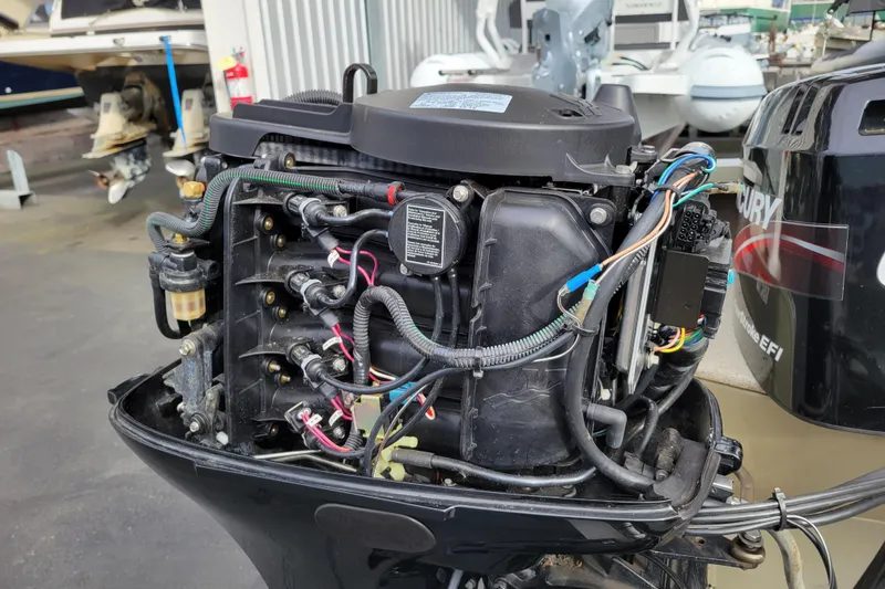 Slide: The Image of 2005 Lowe Fish & Ski 165 boat engine with visible wiring and components. - 26