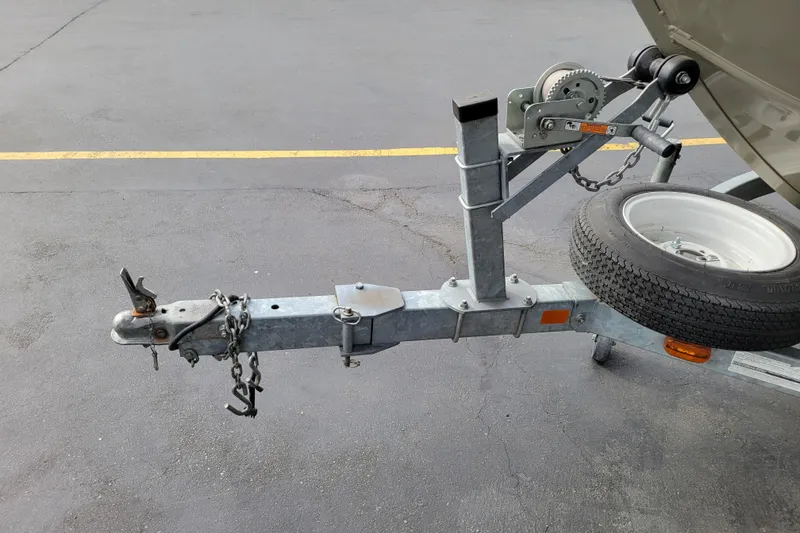 Slide: The Image of Trailer hitch and spare tire of a 2005 Lowe Fish & Ski 165 boat. - 28