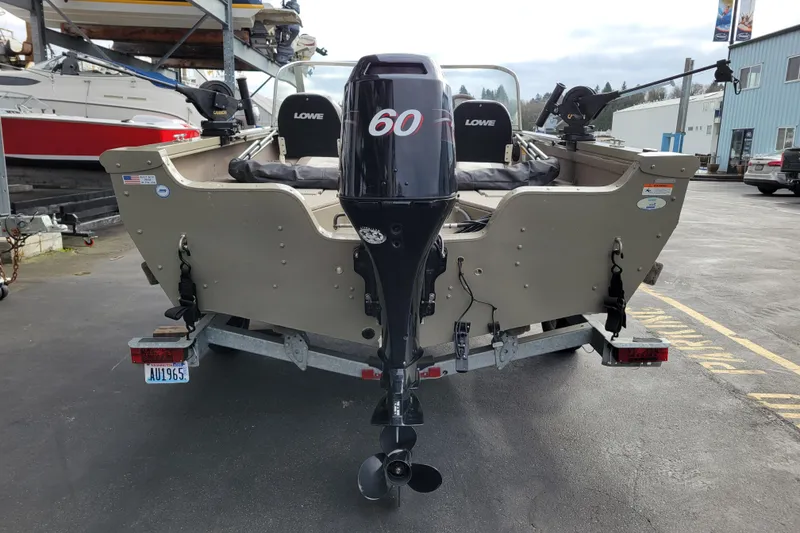 Slide: The Image of 2005 Lowe Fish & Ski 165 boat with 60 HP motor, parked on a trailer. - 3
