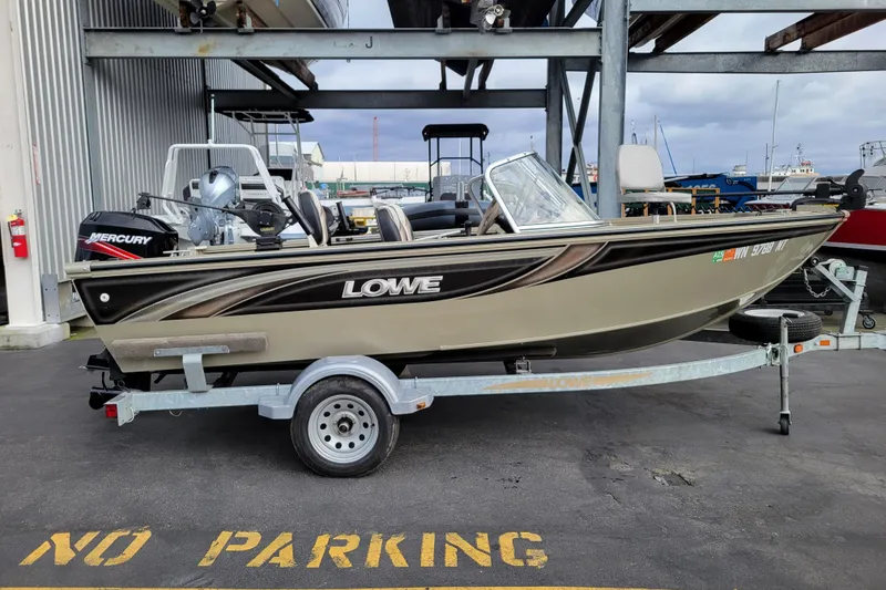 Slide: The Image of 2005 Lowe Fish & Ski 165 boat on trailer, parked in marina area. - 5