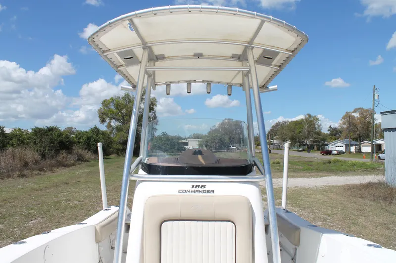 Slide: The Image of 2016 Sea Fox 186 Commander boat with T-top, parked outdoors under blue sky. - 11