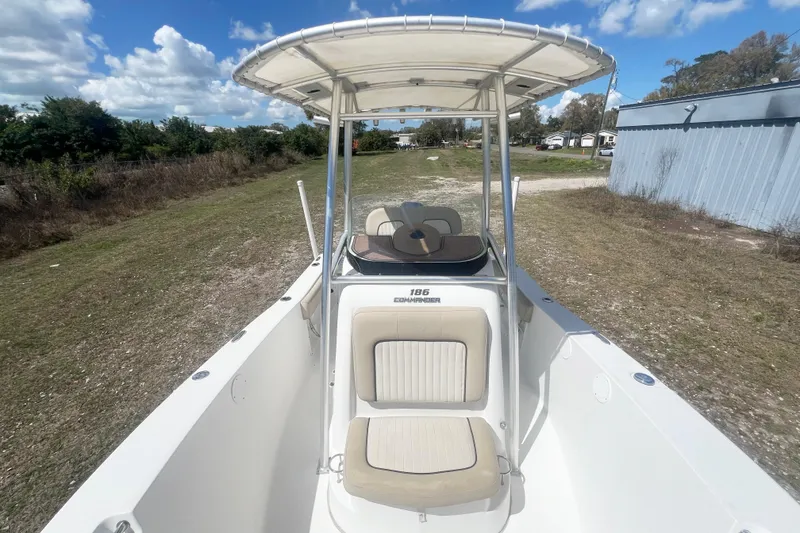 Slide: The Image of 2016 Sea Fox 186 Commander boat with T-top, parked on grassy area under blue sky. - 17