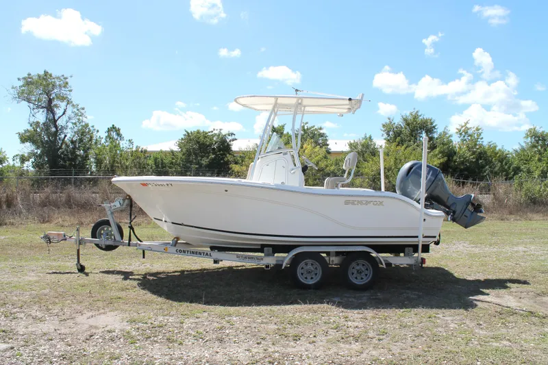 Slide: The Image of 2016 Sea Fox 186 Commander boat on trailer, parked outdoors under a clear blue sky. - 6