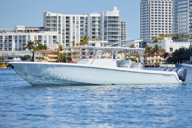 The Image of 2022 Contender 44 Fisharound boat cruising near urban waterfront buildings. - 0