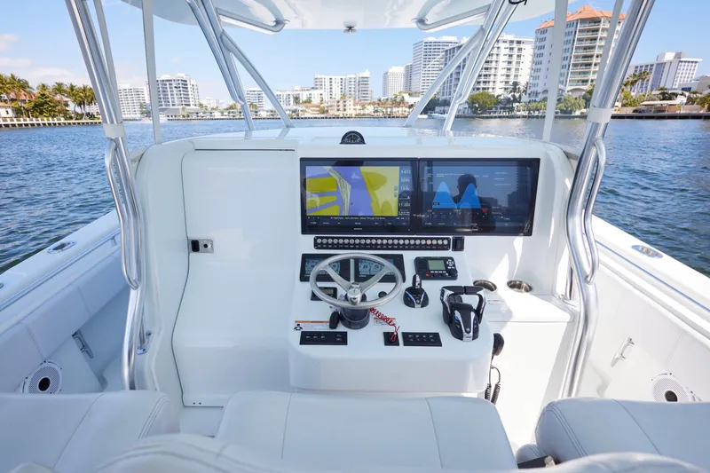 Slide: The Image of 2022 Contender 44 Fisharound helm with advanced navigation displays and controls. - 11