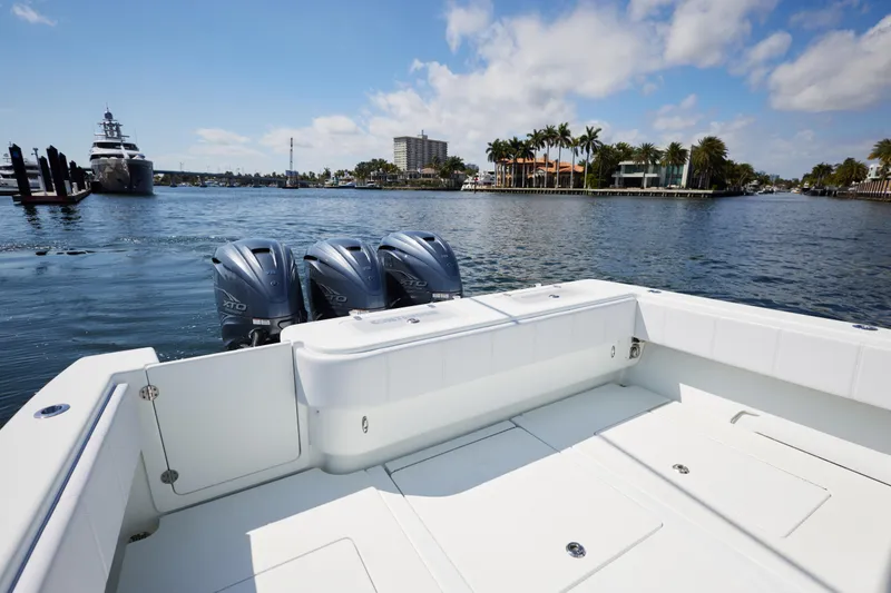 Slide: The Image of 2022 Contender 44 Fisharound boat with triple engines on a sunny waterfront. - 13