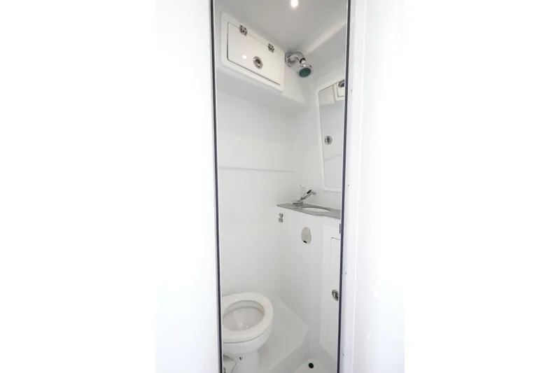 Slide: The Image of 2022 Contender 44 Fisharound boat bathroom with toilet and sink. - 19