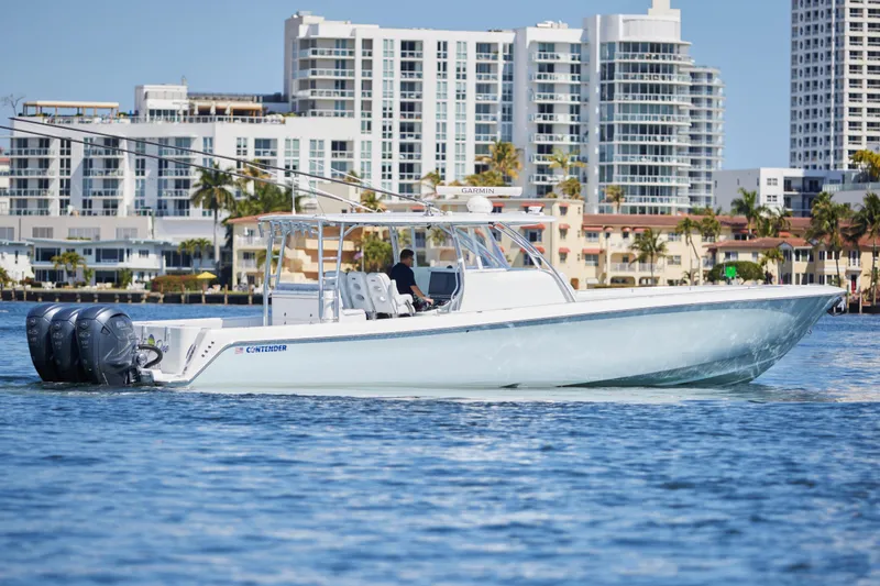 Slide: The Image of 2022 Contender 44 Fisharound boat cruising near city waterfront. - 3