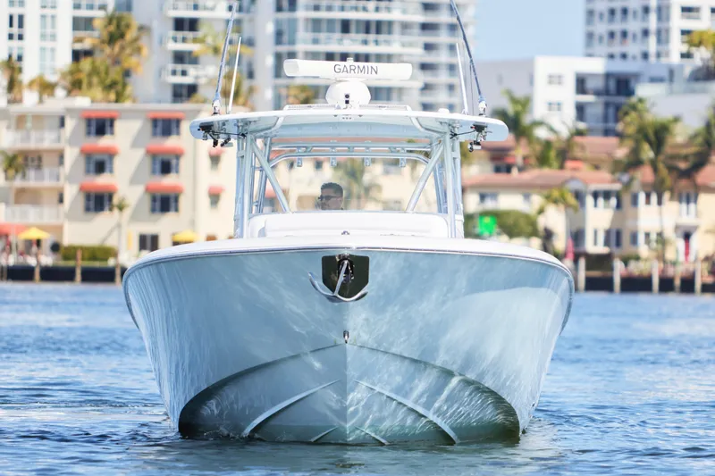 Slide: The Image of 2022 Contender 44 Fisharound boat cruising near urban waterfront buildings. - 4