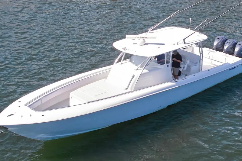 Slide: The Image of 2022 Contender 44 Fisharound boat on water, featuring sleek design and triple engines. - 8