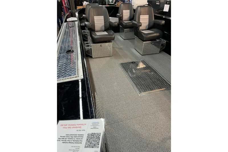 Slide: The Image of 2026 RH Boats 23 Commander interior with sleek seating and diamond plate flooring. - 6