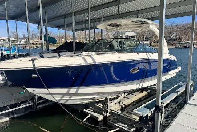 The Image of 2021 Chaparral 307 SSX boat docked under a covered marina. - 0