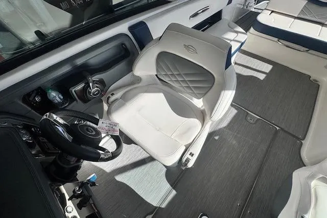 Slide: The Image of 2021 Chaparral 307 SSX boat interior with steering wheel and cushioned seating. - 11