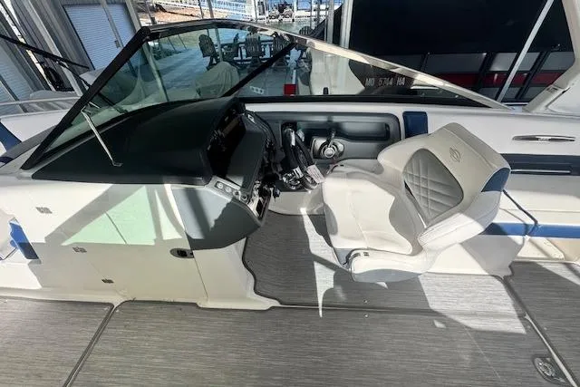Slide: The Image of 2021 Chaparral 307 SSX boat cockpit with steering wheel and cushioned seat. - 12