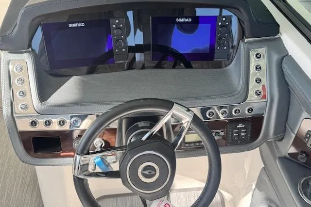 Slide: The Image of 2021 Chaparral 307 SSX dashboard with dual Simrad displays and modern steering wheel. - 13