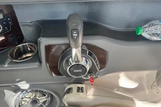 Slide: The Image of 2021 Chaparral 307 SSX boat throttle control with cup holder and speaker. - 14