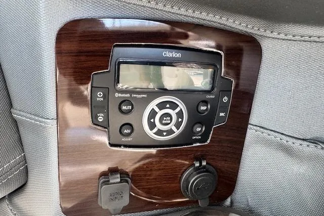 Slide: The Image of Clarion audio system in 2021 Chaparral 307 SSX boat, featuring Bluetooth and AUX input. - 15