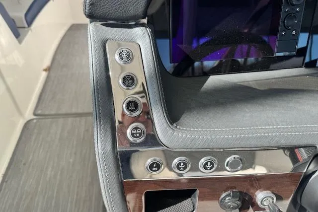 Slide: The Image of Control panel of a 2021 Chaparral 307 SSX boat with various buttons and switches. - 16