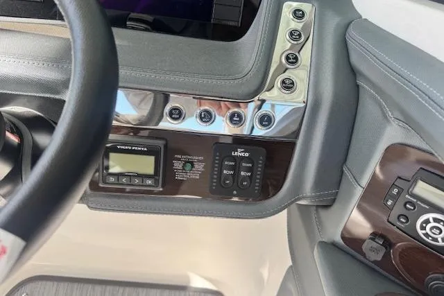 Slide: The Image of 2021 Chaparral 307 SSX dashboard with control panel and steering wheel. - 17