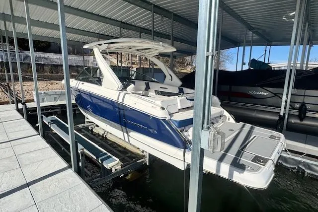 Slide: The Image of 2021 Chaparral 307 SSX boat docked in a covered marina. - 2