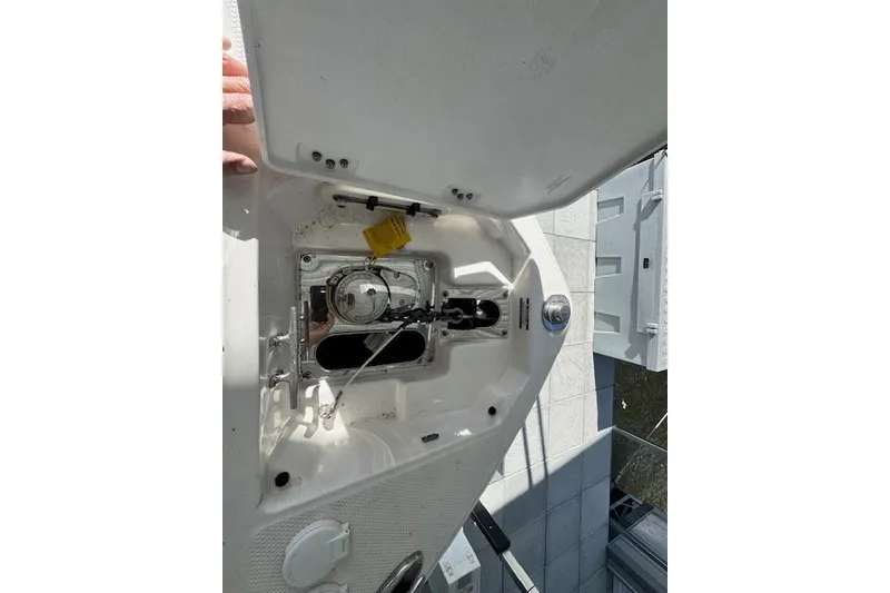 Slide: The Image of 2021 Chaparral 307 SSX boat interior compartment with open hatch and visible components. - 22