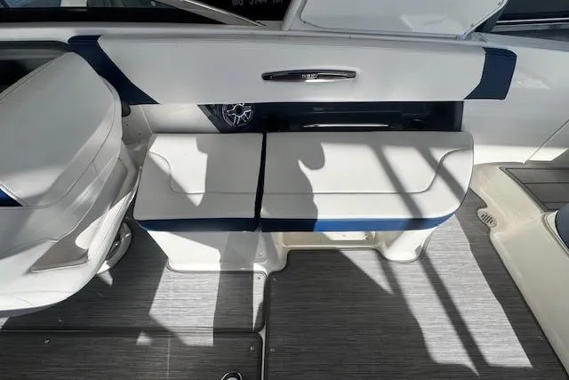 Slide: The Image of 2021 Chaparral 307 SSX boat interior with white and blue seating. - 24