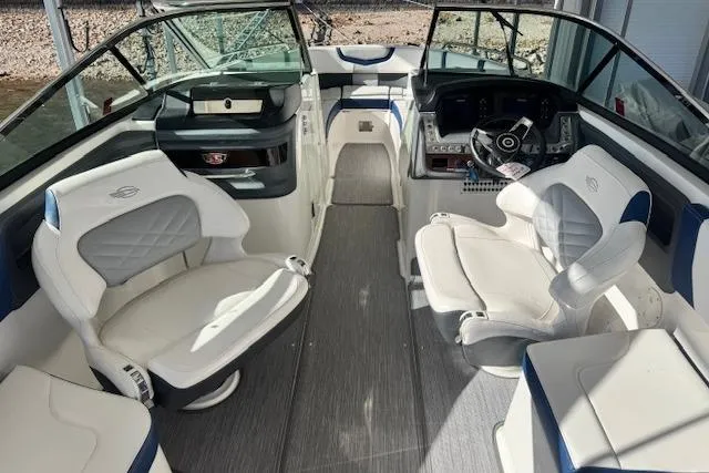 Slide: The Image of 2021 Chaparral 307 SSX boat interior with white seating and modern dashboard. - 26